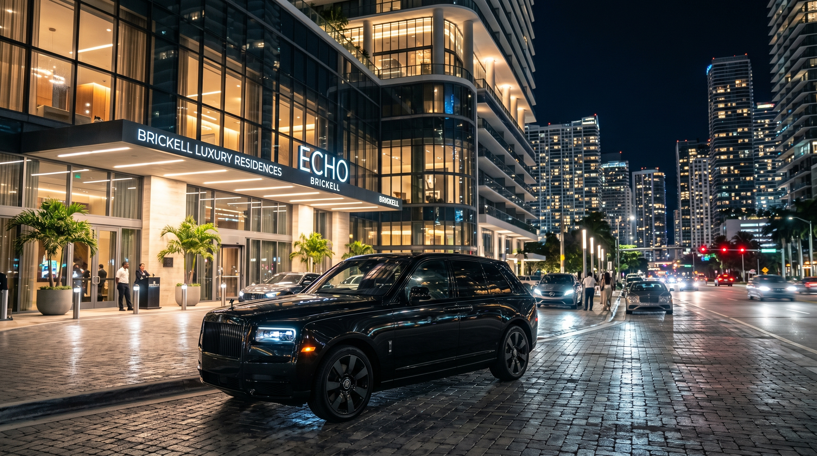Rolls-Royce Cullinan Black Badge parked in front of Brickell luxury high-rise at night, city lights
